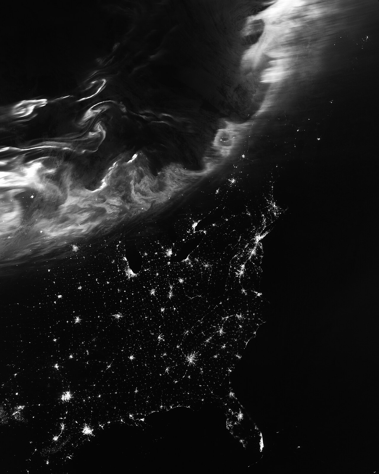 Satellite night view of orbital aurora ribbons and city lights